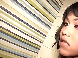 skinny ladyboy in black dress strokes her big cock on the sofa